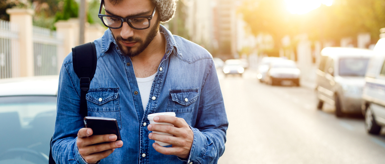 man with cup and phone