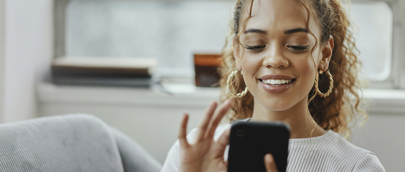 woman with golden earrings and phone